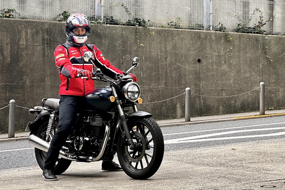 Dustin in full gear posing for a photo on a Yamaha XSR900 in Tokyo