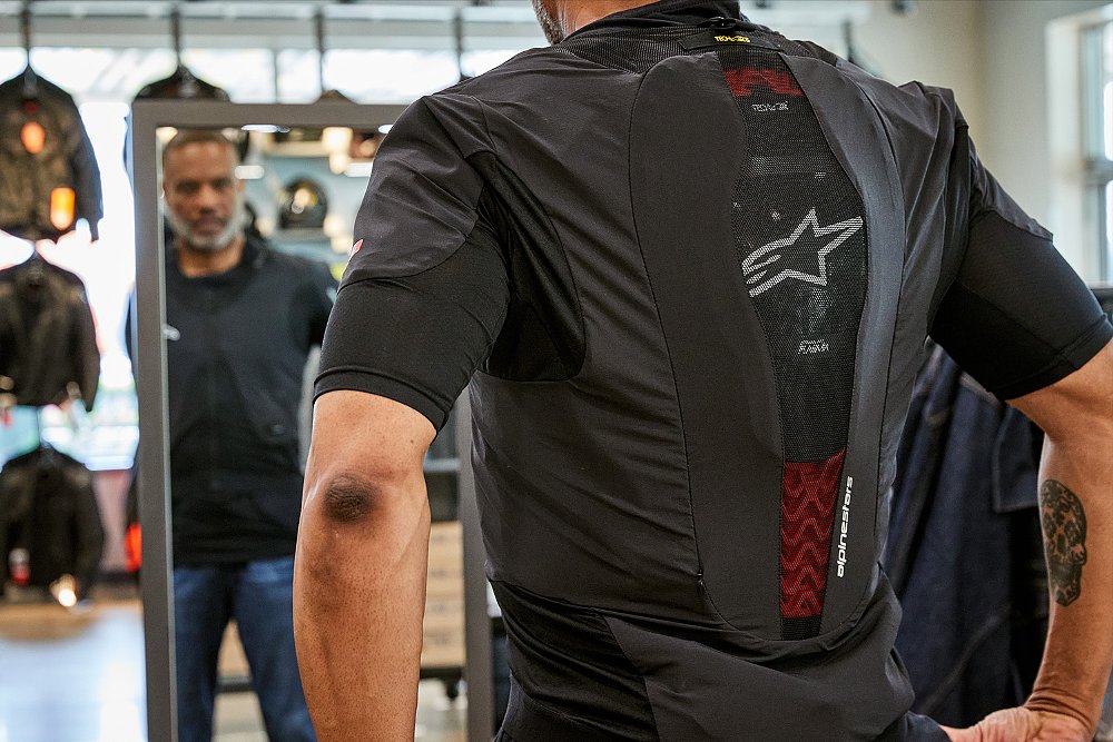 A Cycle Gear customer tries on an Alpinestars Tech-Air 5 Plasma.