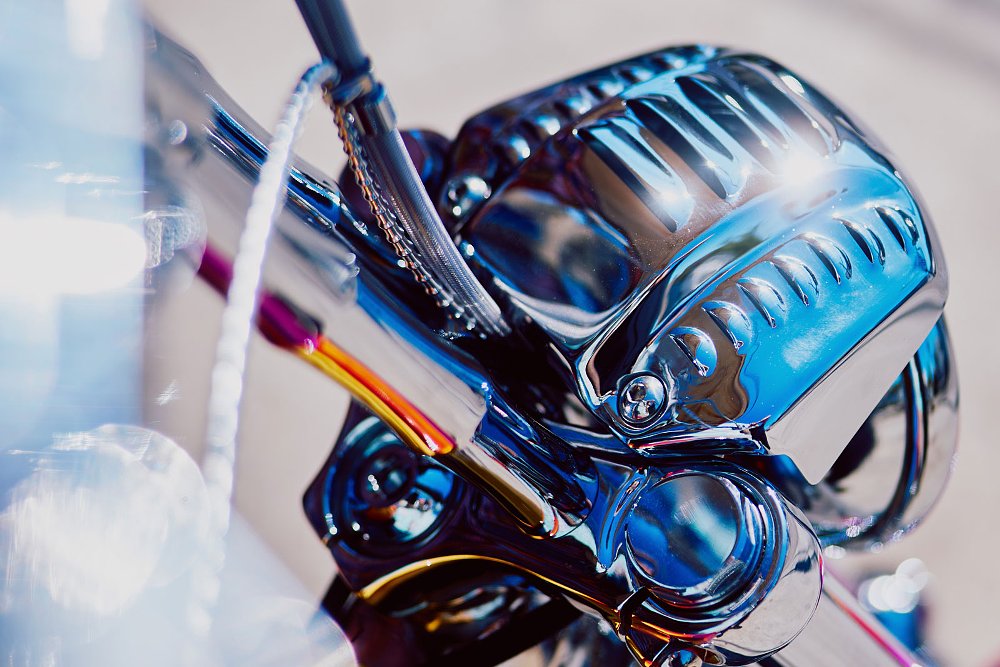 close view of chromed parts on and around the handlebar
