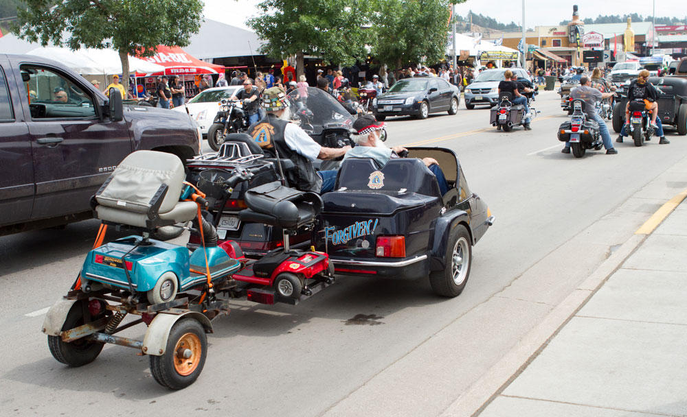 biker towing scooter
