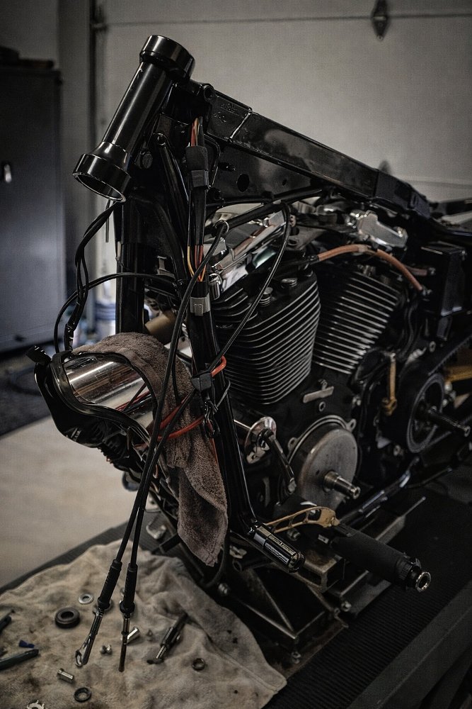 Harley-Davidson motorcycle on the lift in the shop, partially disassembled, in the middle of the project