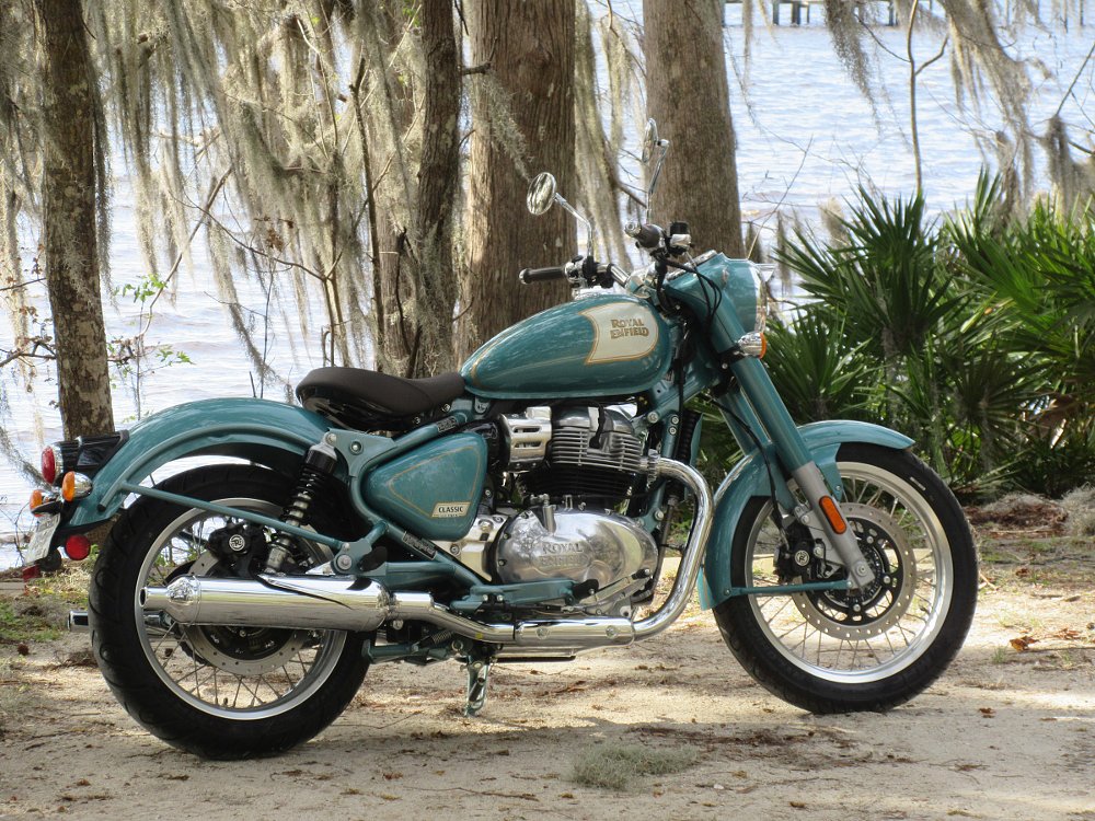 teal Classic 650 sitting by a lake under a tree dripping with Spanish moss