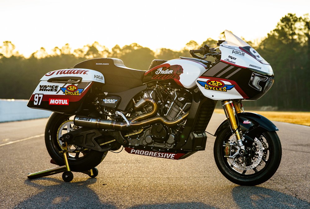 side view of the race bike parked at the track at sunset