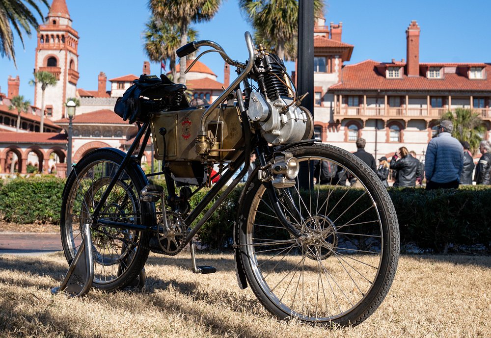 side view of the 1901 motorcycle, similar to a bicycle with an engine mounted on the front handlebar