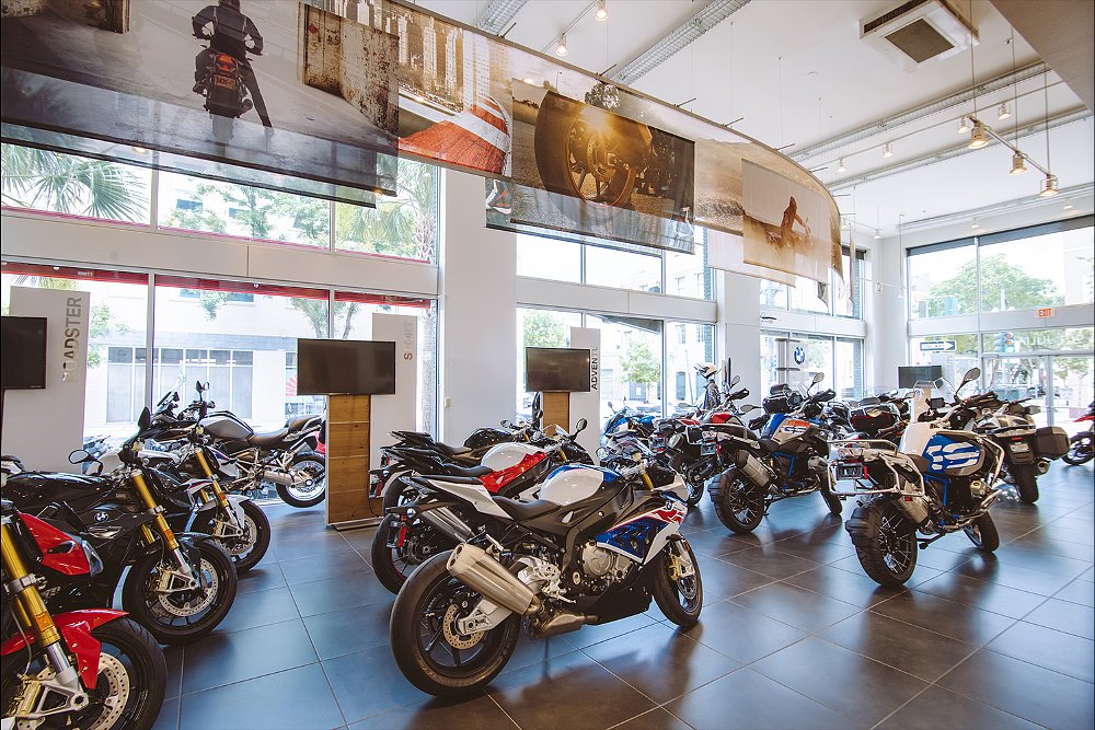 The interior view of BMW dealership, with bikes arranged in rows.