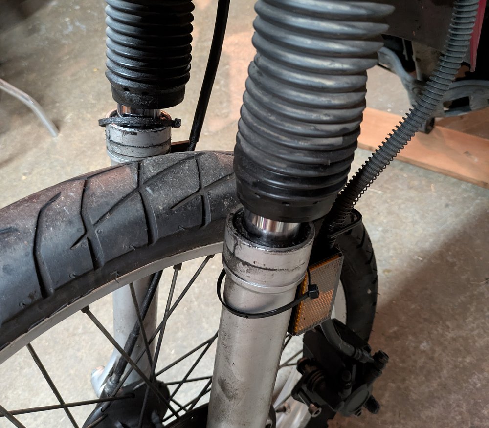 close view of dirty fork legs with leaking seals