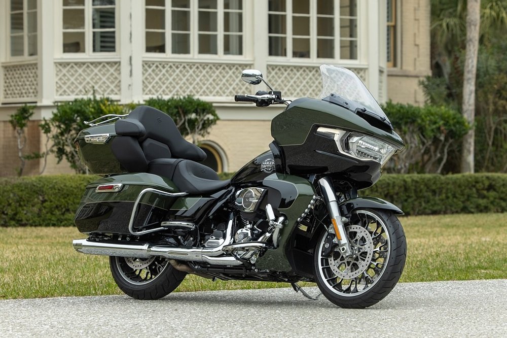 two-tone green and black Road Glide Limited parked in front of a historic building
