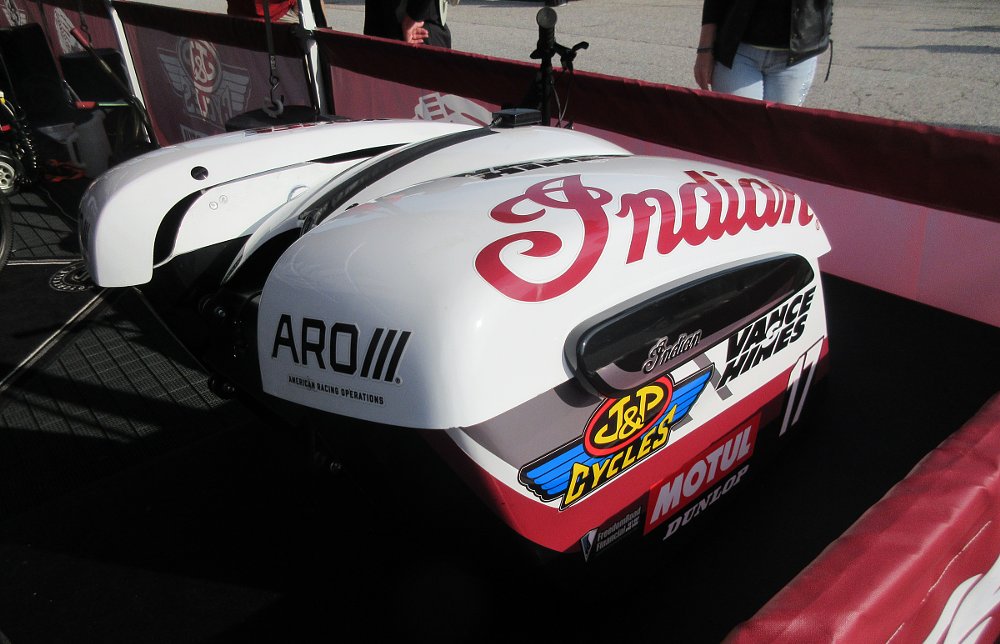 rear bags and tail section in the paddock with sponsor stickers, including J&P Cycles