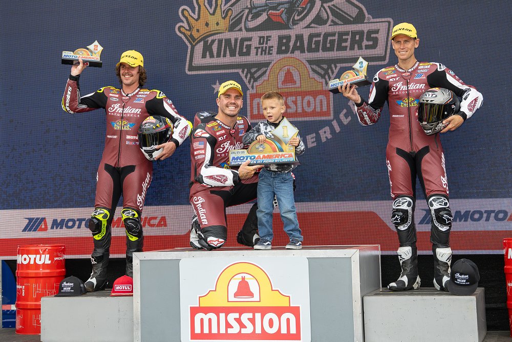 the three riders celebrate on the podium after Sunday's race
