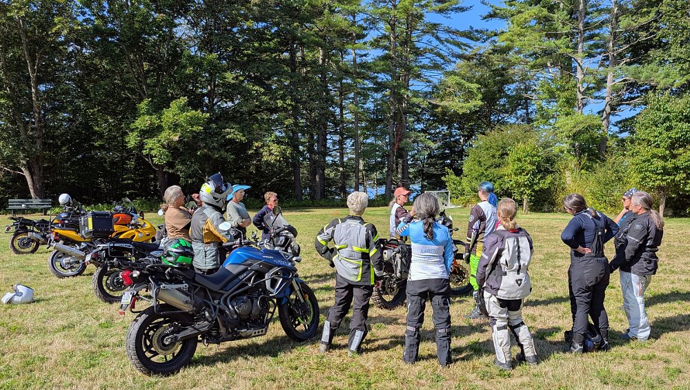 women and their adventure motorcycles practicing in a field