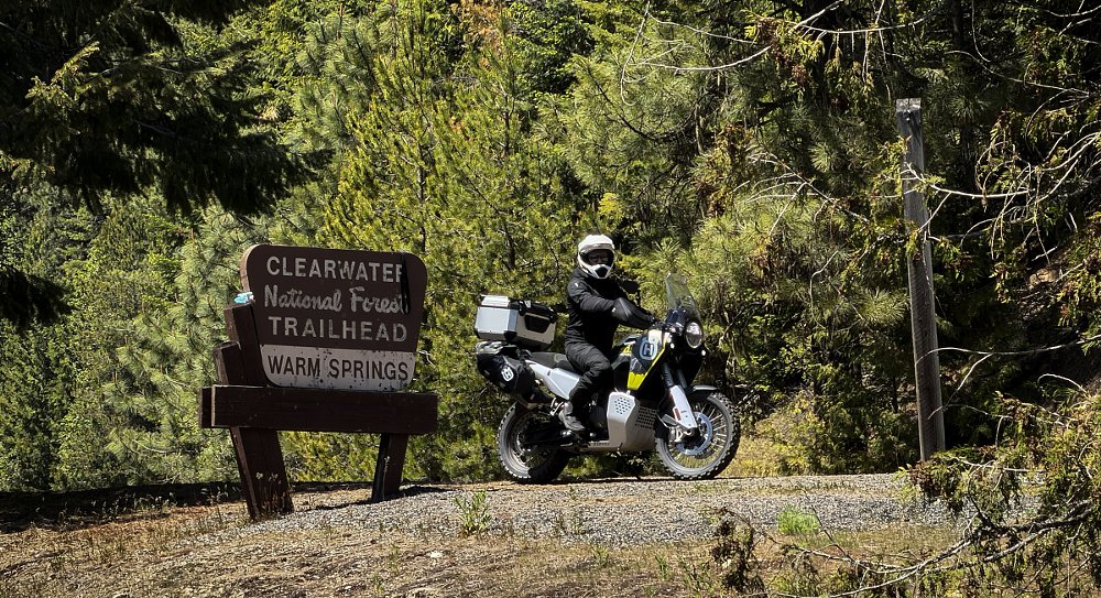 motorcyclist stopped by sign for warm springs in the Clearwater National Forest