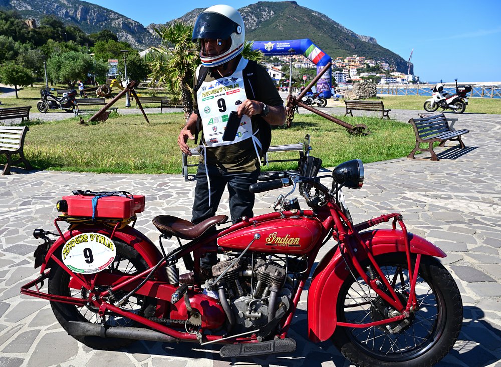 Nawal posing beside his red antique Indian motorcycle