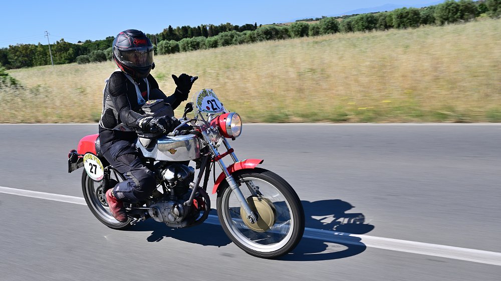 woman riding a small Ducati in the Giro