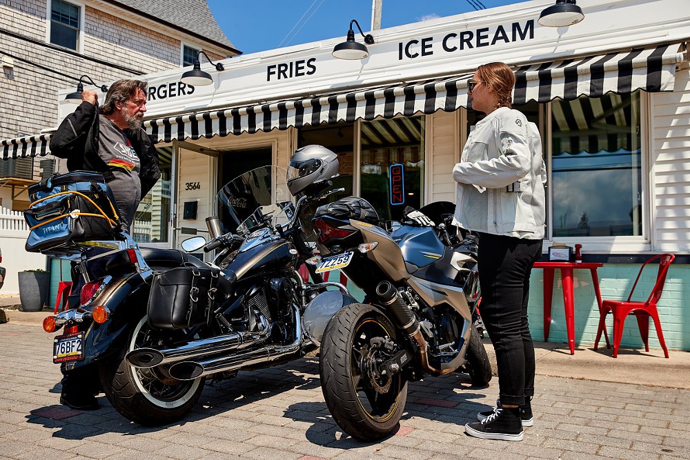 father and daughter on a motorcycle ride, outside a seaside burger shack