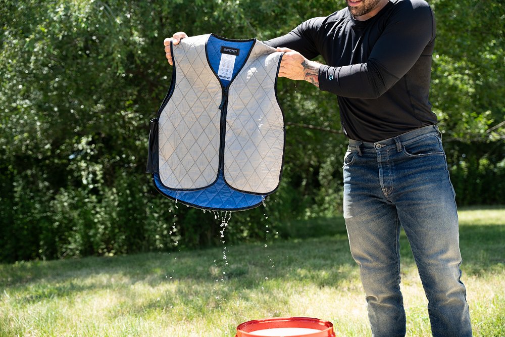 a Sedici cooling vest dripping after being dunked in a bucket of water