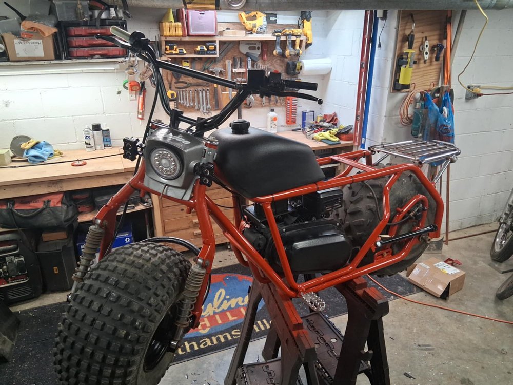 partially assembled minibike in the shop