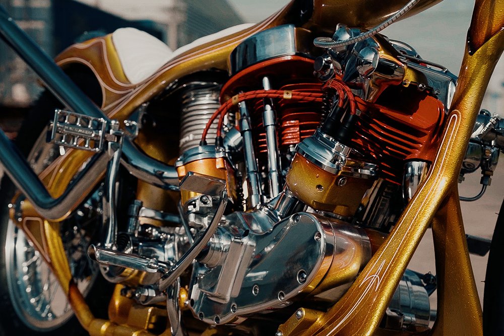 close view of orange-painted V-twin engine