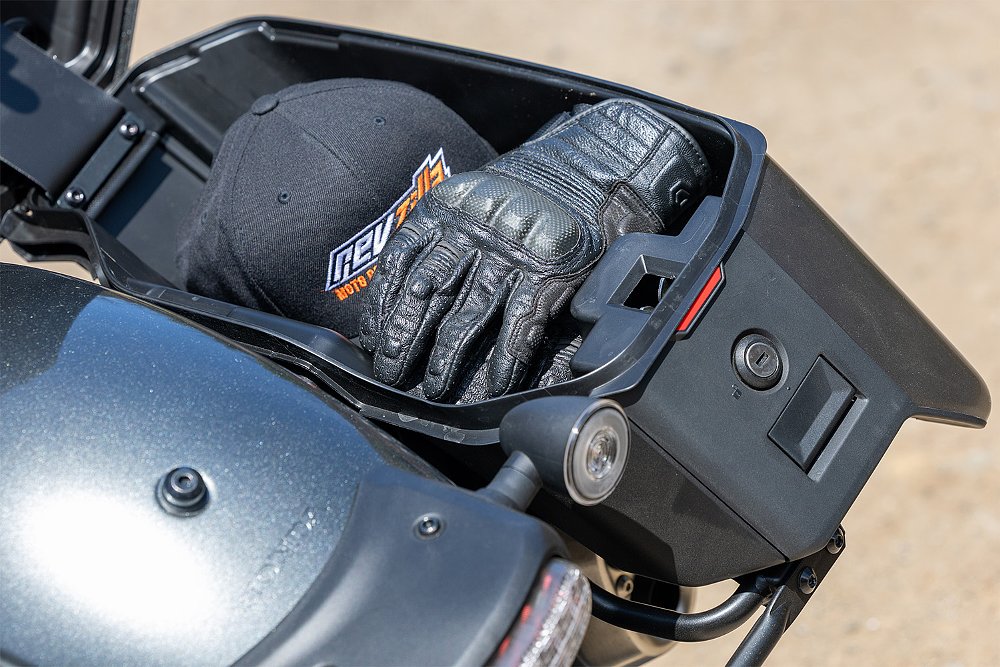The Rebel 1100T's right saddlebag filled with a pair of gloves and a baseball cap.