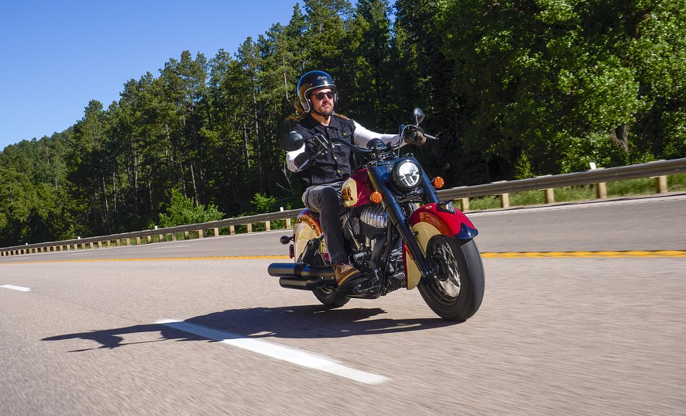 rider on the open road on the Indian Chief Vintage Sturgis, SD Edition in slanting sunlight