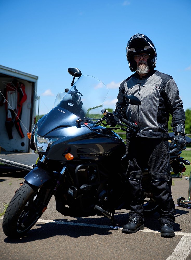 Berrettini geared up, standing beside his motorcycle