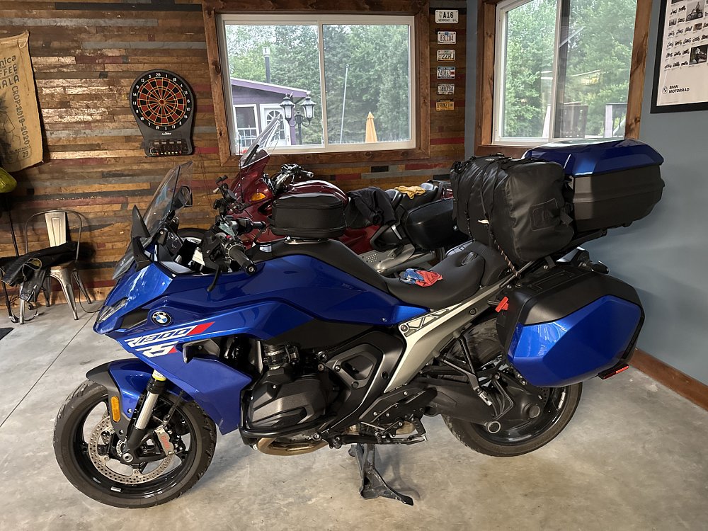 blue BMW R 1300 RS with saddlebags and top box and another bag on the passenger seat