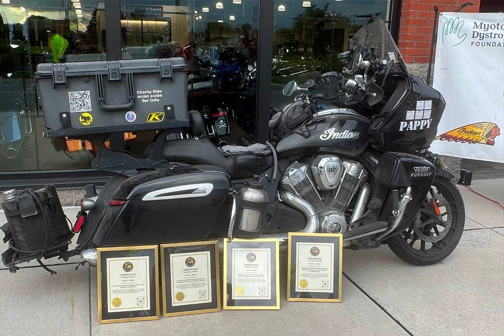 Four world record plaques staged before Patrick Cornell's parked Indian Pursuit.
