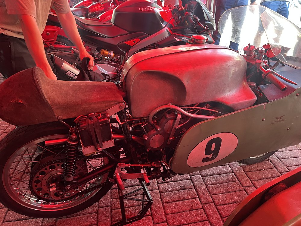 the old race motorcycle with a huge dustbin fairing under a tent