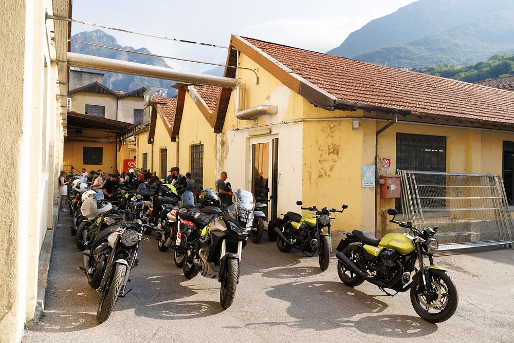 row of new motorcycles outside the old factory building