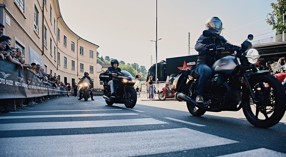 riders on the streets of Mandello del Lario with spectators lining the sides