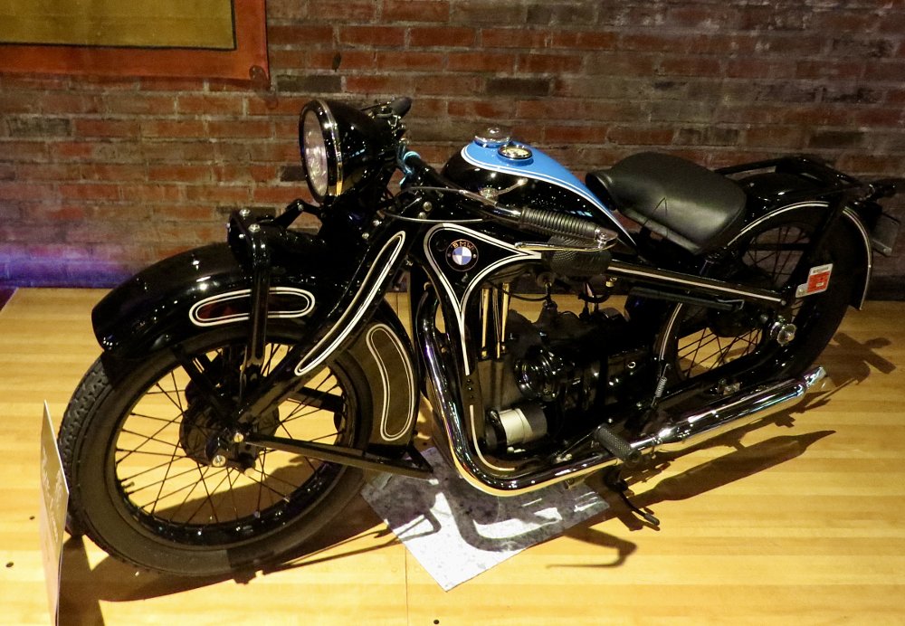 a black BMW with swoopy bodywork and blue accents with white pinstripes