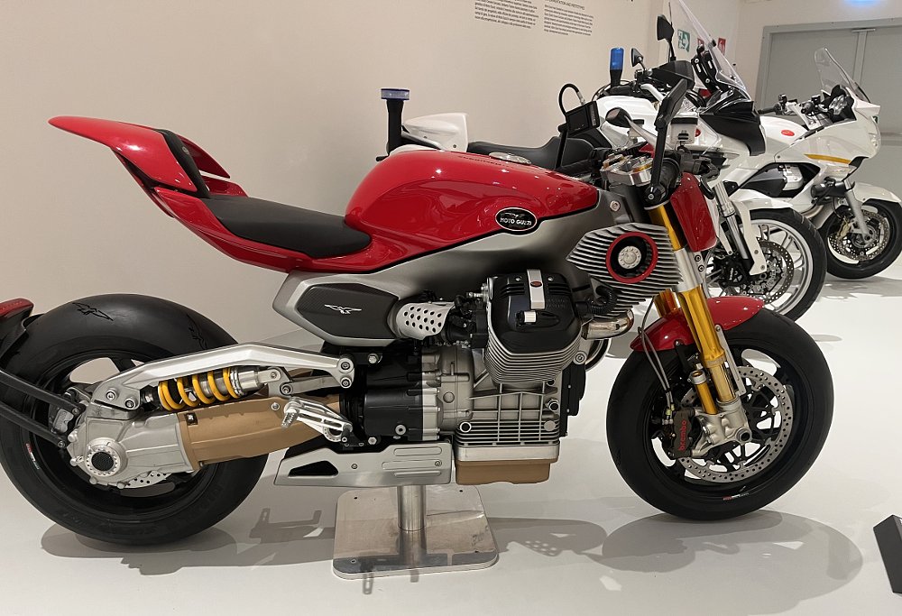 an unfaired red concept motorcycle on display in the museum