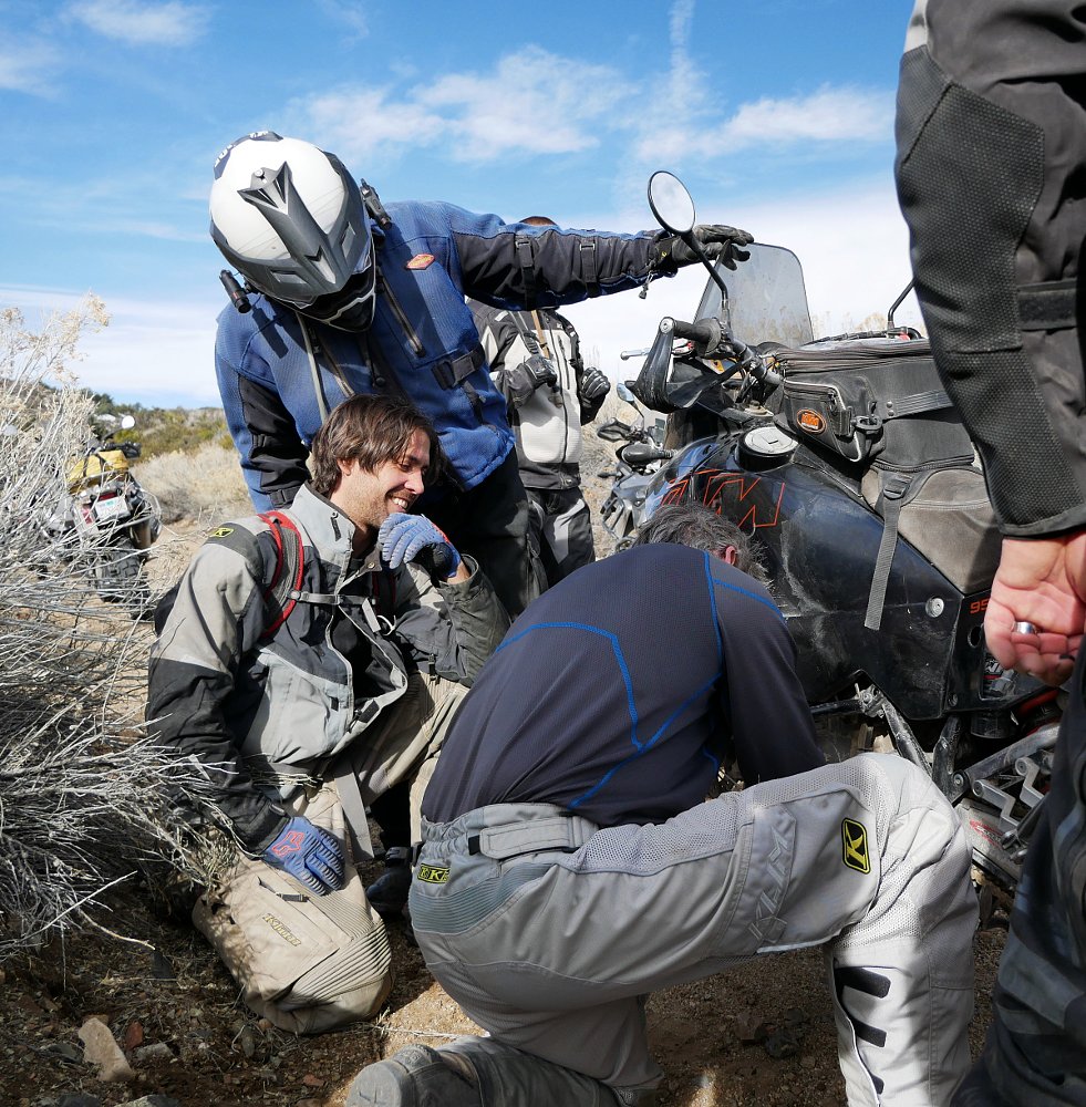 repairing a motorcycle on the trail