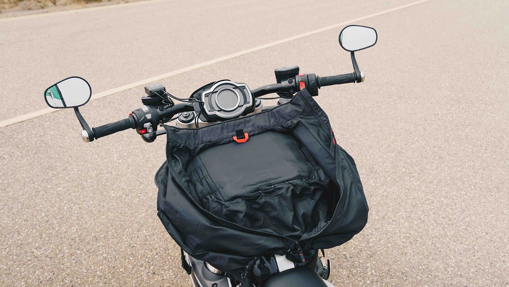 Triumph Rocket 3 cockpit with homemade heated vest to carry pizzas mounted to fuel tank