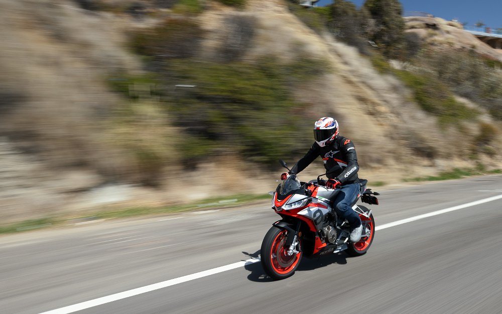 tracking photo of Aprilia's Tuono 660 riding along a straight road
