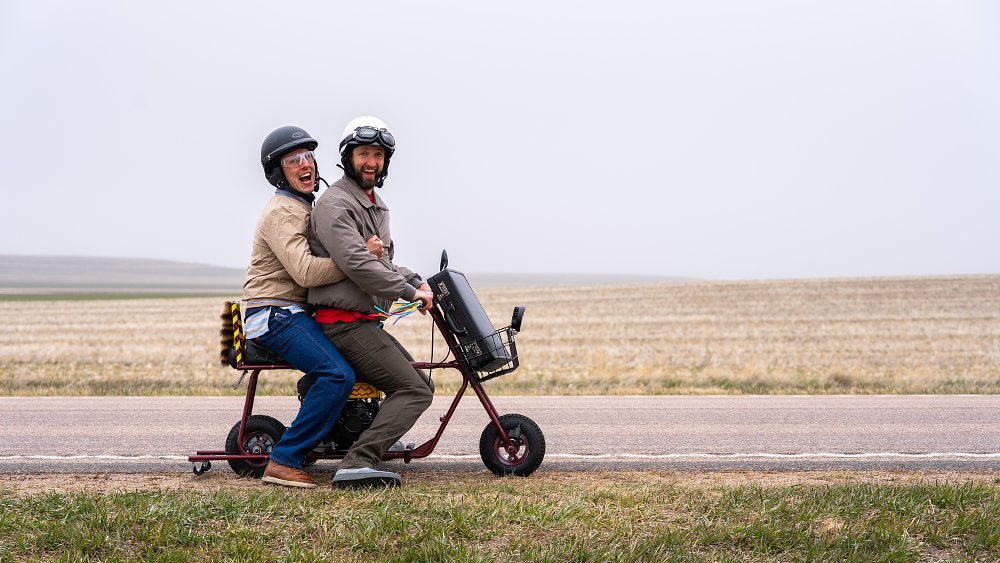 Two men on a Dumb and Dumber replica mini bike