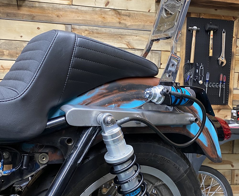 custom mounts for shock reservoirs on the side of the motorcycle