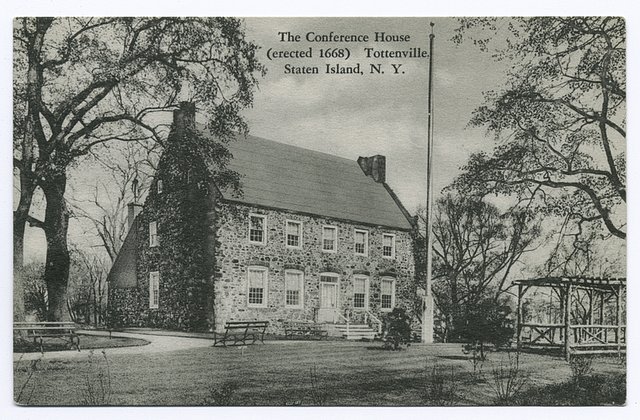 a black and white photo of the small stone cottage known as Conference Cottage