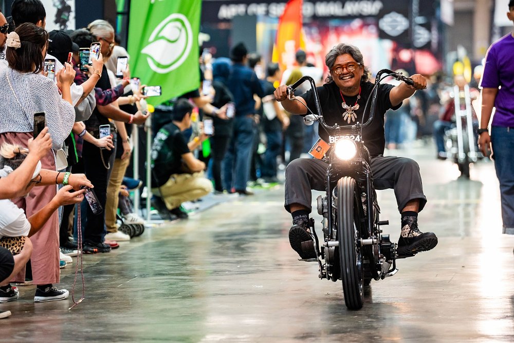 festival organizer Asep riding in on a chopper