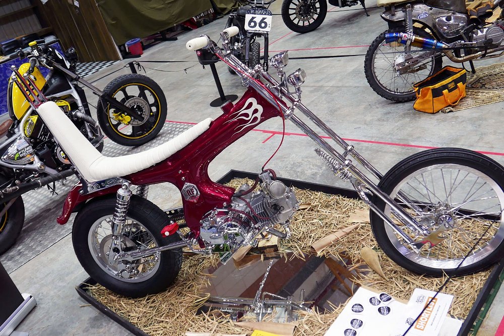 small, bright red chopper built on a 90 cc bike