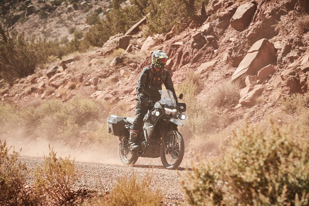 Kawasaki KLR650 rider on a dirt desert road