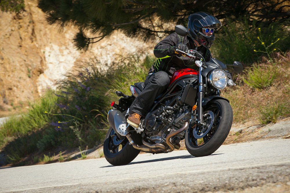 Spurgeon wearing white sunglasses while riding the SV650 on a mountain road