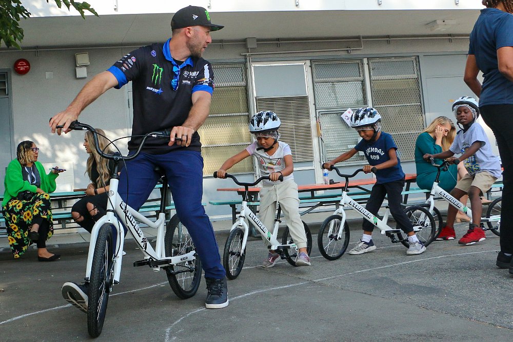 Eli Tomac leads kids on a bicycle ride