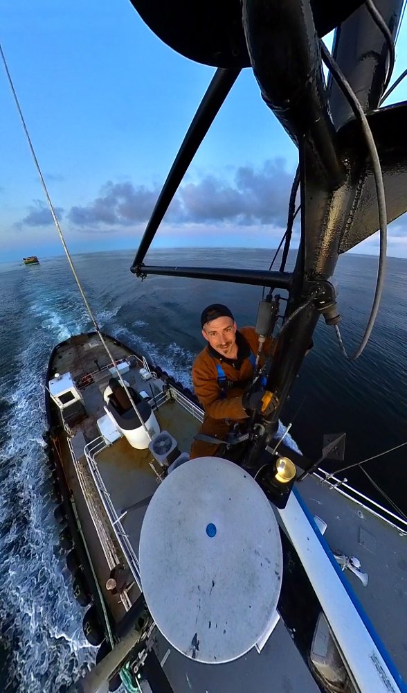 climbing the mast on a boat at sea