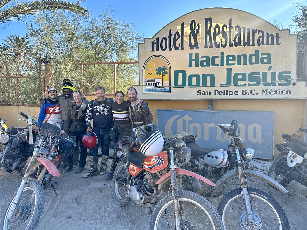 the group of riders in front of the hotel
