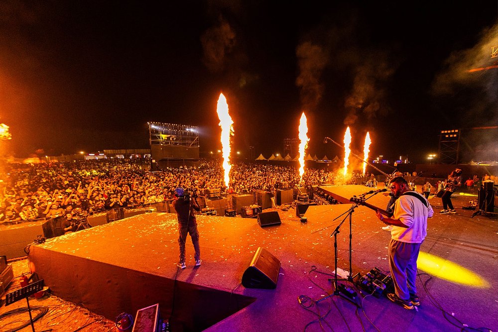 a band performing on stage in front of a large crowd