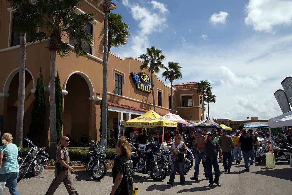 crowds of people and motorcycles in front of the J&P store
