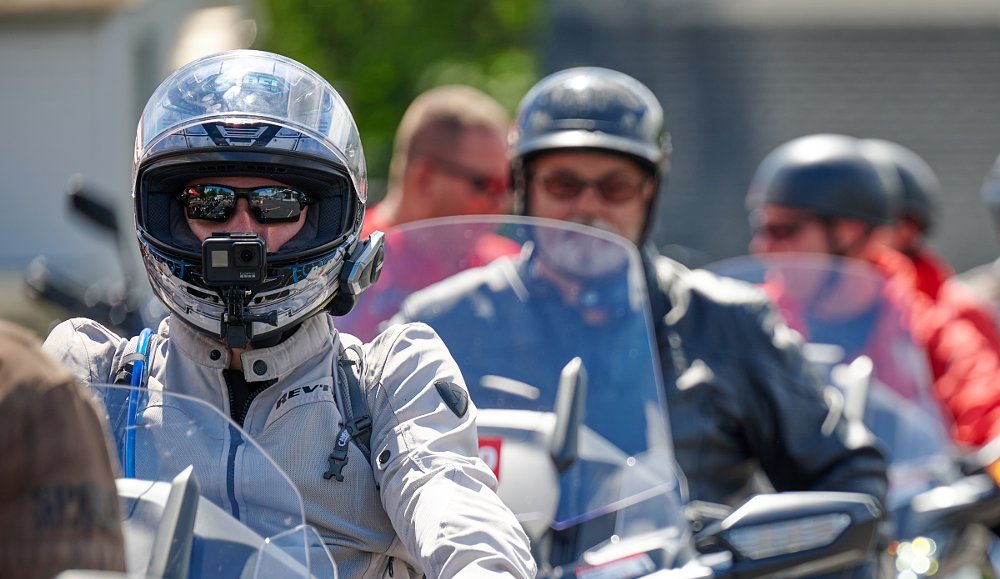 riders wearing different kinds of motorcycle helmets with glasses