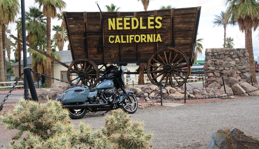 Street Glide parked in front of old wagon in Needles, California