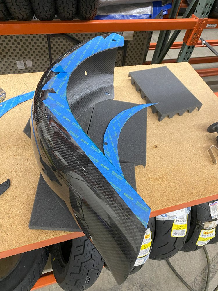 carbon fiber fender marked for cutting with tape