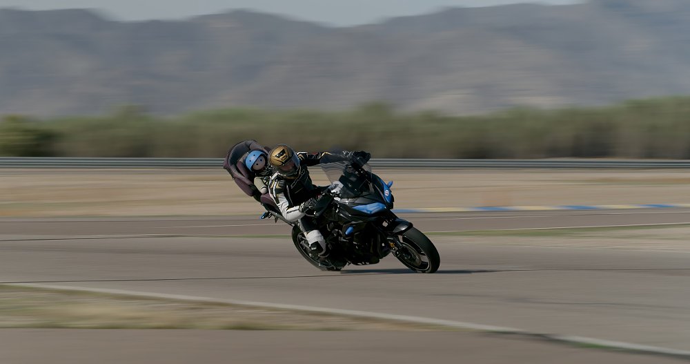 motorcycle on a race track with a baby figure in a car seat